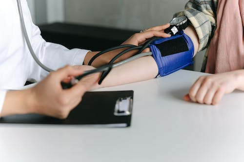 Family Medicine Doctor Checking Patient’s Blood Pressure 