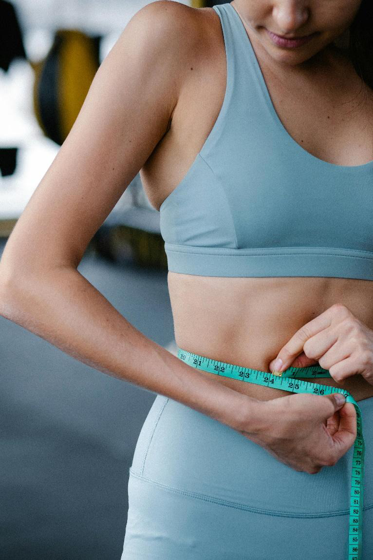 A picture of a person measuring their waist